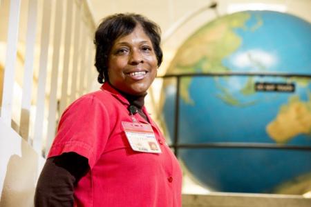 Margaret Bolton stands before the Geography building globe